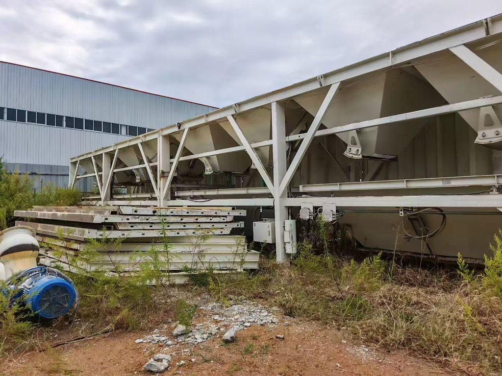 Actual aggregate batching structure with hoppers photographed laid down at the used SANY HZS180 plant site